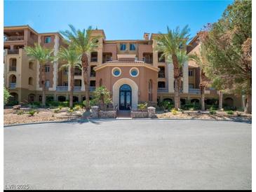 Stunning exterior view of a luxury building with manicured landscaping and towering palm trees at 20 Via Mantova # 306, Henderson, NV 89011