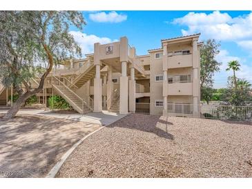 Multi-level condo building with beige exterior, open stairways, and landscaped grounds at 2007 Cutlass Dr # 0, Henderson, NV 89014