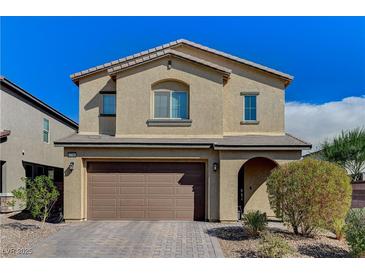Two-story home featuring a two-car garage, arched entry and desert landscaping under a bright blue sky at 2796 Sipe Springs St, Las Vegas, NV 89142