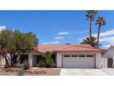 Charming single-story home features a tile roof, mature landscaping, and an attached two-car garage at 3024 Nutwood St, Las Vegas, NV 89108