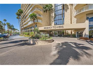 Regency Towers building entrance with manicured landscaping and easy circular access at 3111 Bel Air Dr # 18B, Las Vegas, NV 89109