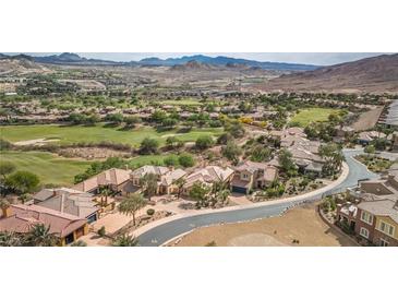 Stunning aerial view of a luxury home in a golf course community with mountain views at 32 Cerchio Basso, Henderson, NV 89011