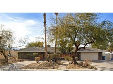 Charming single-story home with desert landscaping, mature trees, and a spacious driveway at 3845 S Torrey Pines Dr, Las Vegas, NV 89103
