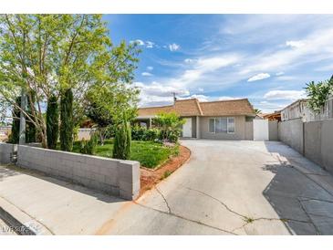 Charming single-story home with mature landscaping, a driveway, and a well-maintained front yard at 4393 Swandale Ave, Las Vegas, NV 89121