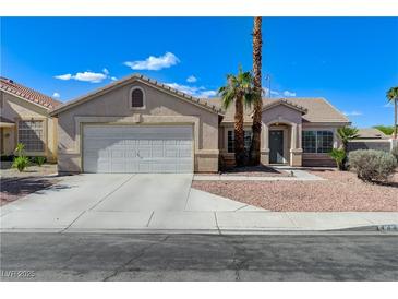 Charming single-story home with a well-maintained front yard, two-car garage, and desert landscaping at 444 Flores Cir, Las Vegas, NV 89123