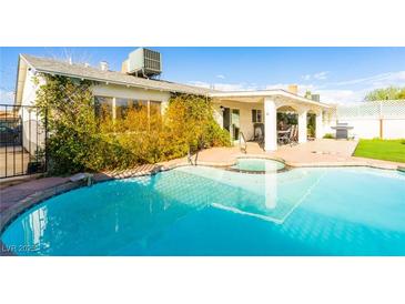 Inviting pool and covered patio, perfect for outdoor relaxation and entertaining at 4471 Wisconsin Ave, Las Vegas, NV 89104