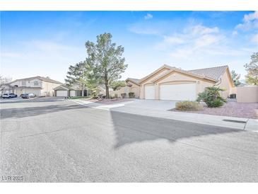 Charming single-story home with a well-maintained front yard and attached two-car garage at 5405 Lucky Clover St, Las Vegas, NV 89149