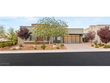 Beautiful single-story home with desert landscaping and an elegant garage door at 6194 Stone Rise St, Las Vegas, NV 89135