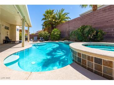 Inviting pool and spa area with mature landscaping and lounge seating at 6251 Tuckaway Cove Ave, Las Vegas, NV 89139