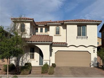Charming two-story home with a two-car garage, a red tile roof, and desert landscaping at 632 Cadence Vista Dr, Henderson, NV 89011