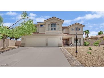Inviting two-story home with a three-car garage, balcony and desert landscaping at 7211 Heggie Ave, Las Vegas, NV 89131