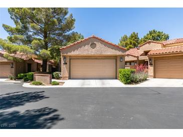 Charming home with a two-car garage, desert landscaping, and a tile roof at 7217 Mission Hills Dr, Las Vegas, NV 89113