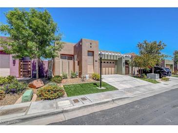 Attractive single-story home featuring a well-manicured lawn and a charming desert landscape at 130 Twin Towers Ave, Las Vegas, NV 89123