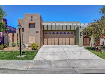 Inviting single-story home featuring a spacious driveway and appealing desert landscaping at 130 Twin Towers Ave, Las Vegas, NV 89123
