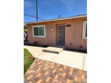 Charming single-story home with a secure front door and well-maintained walkway at 1972 H St, Las Vegas, NV 89106