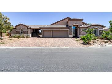 Inviting one-story home featuring a three-car garage and a beautifully paved driveway at 3906 Jacob Lake Cir, Las Vegas, NV 89118