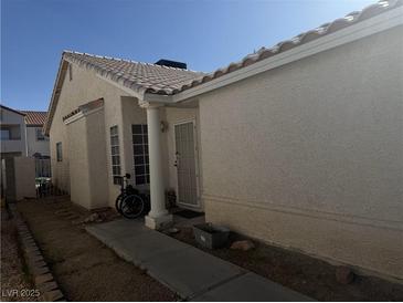Modest single-story home with a tiled roof and simple landscaping at 4607 Chestnut Blaze Dr, North Las Vegas, NV 89032
