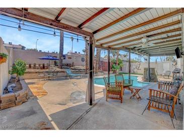 Inviting backyard with a covered patio and a refreshing pool, perfect for outdoor entertaining at 5019 Lancaster Dr, Las Vegas, NV 89120