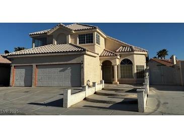 Charming two-story home featuring a well-maintained lawn, classic stucco finish, and a two-car garage at 529 Rancho Del Mar Way, North Las Vegas, NV 89031