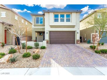 Charming two-story home featuring a brick-paved driveway and a well-maintained, drought-resistant landscaped yard at 7733 Rosebark Cliffs St, North Las Vegas, NV 89084