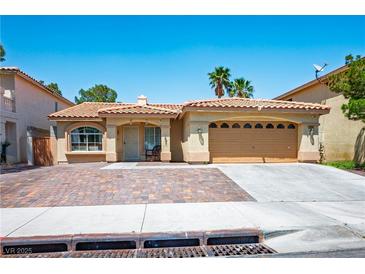 Charming single-story home with a well-manicured front yard and a two-car garage at 8504 W Gilmore Ave, Las Vegas, NV 89129