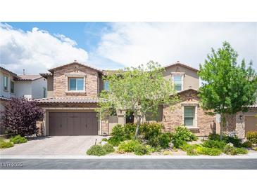Charming two-story home featuring a brick facade, well-maintained landscaping, and a spacious three-car garage at 12018 Vento Forte Ave, Las Vegas, NV 89138