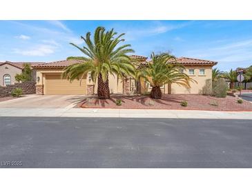 Inviting single-story home featuring a tile roof, desert landscaping and a two-car garage at 2318 Shorewood Hills Ave, Henderson, NV 89052