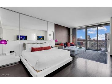 Contemporary main bedroom featuring a mirrored wall and seating area with city views at 4381 W Flamingo Rd # 3120, Las Vegas, NV 89103