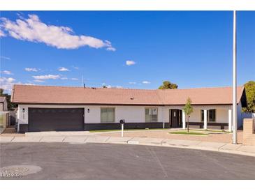 Charming single-story home featuring a tile roof, two-car garage, and well-maintained landscaping on a sunny day at 4454 Harmony Ct, Las Vegas, NV 89121
