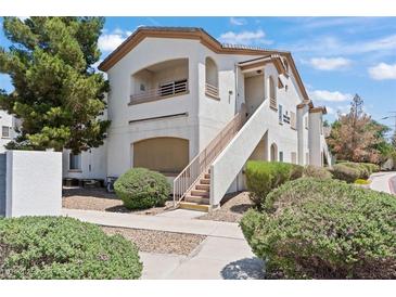 Well-maintained condominium with lush landscaping, covered entry, and private balcony, showcasing inviting curb appeal at 5655 E Sahara Ave # 2044, Las Vegas, NV 89142