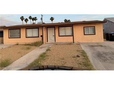 Single story home with a low-maintenance front yard and a long driveway at 621 Van Ert Ave, North Las Vegas, NV 89030