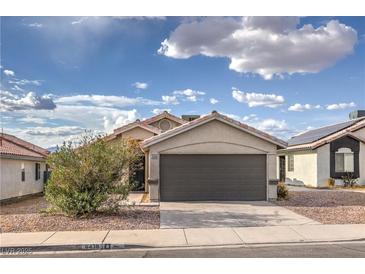 Charming single story home featuring a two car garage and low maintenance desert landscaping at 6438 Rose Tree Ln, Las Vegas, NV 89156