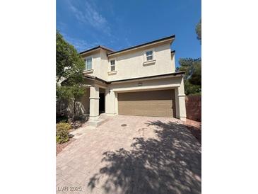 A charming two-story home with a two car garage and a brick driveway at 1030 Maple Pines Ave, North Las Vegas, NV 89081