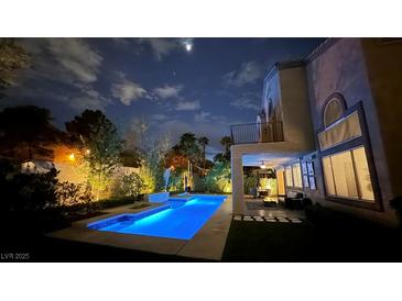 Inviting backyard pool with stylish lounge area, perfect for evening relaxation and enjoyment at 1701 Tesara Vista Pl, Las Vegas, NV 89128