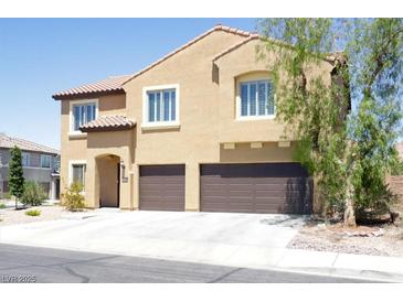 Two-story stucco home boasts a tile roof, two-car garage, and well-maintained landscaping at 176 Jay Porter Ave, Henderson, NV 89002
