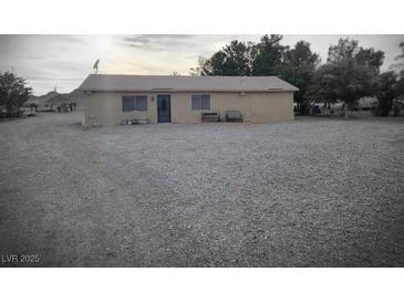 Charming single-story home with neutral stucco exterior and spacious gravel front yard at 1930 N Murphy St, Pahrump, NV 89060