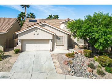 Charming single-story home with a well-manicured front yard and two-car garage in a sunny neighborhood at 1978 Kachina Mountain Dr, Henderson, NV 89012