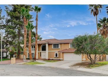 Stunning two-story home features a tile roof and manicured landscaping creating great curb appeal at 2224 Lucerne Ct, Henderson, NV 89014