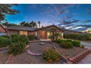 Charming single-story home with a well-manicured front yard and desert landscaping under a colorful dusk sky at 2231 Marlboro Dr, Henderson, NV 89014