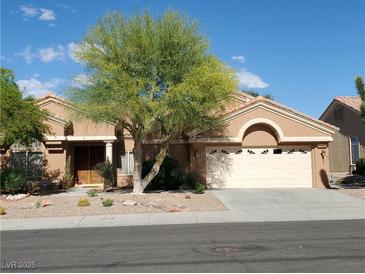 Charming single-story home featuring a well-maintained landscape and inviting curb appeal with a two car garage at 2540 Faiss Dr, Las Vegas, NV 89134