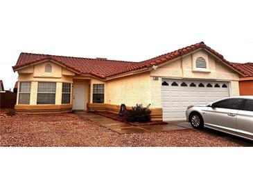 Charming single-story home featuring a terracotta roof, two-car garage, and low maintenance desert landscaping at 2595 Fort Lauderdale Dr, Las Vegas, NV 89156