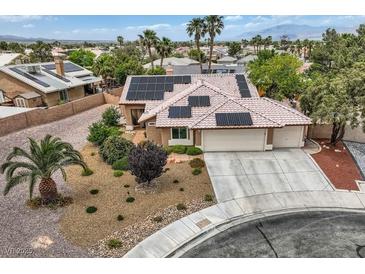 Inviting home featuring a two-car garage, desert landscaping, and solar panels for energy efficiency at 3619 Bixbee Ct, Las Vegas, NV 89129