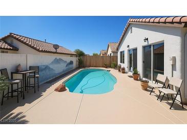 Inviting backyard pool with desert landscape and mountain mural on privacy wall at 3808 Lilac Haze St, Las Vegas, NV 89147