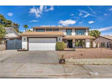 Charming two-story home featuring a two-car garage, mature landscaping, and a welcoming facade at 3916 Green Leaf Dr, Las Vegas, NV 89120