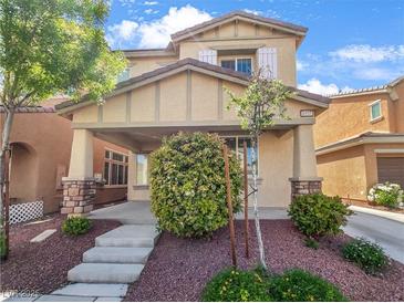 Charming two-story home featuring a landscaped front yard and inviting covered porch at 6537 Ditmars St, Las Vegas, NV 89166