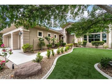 Charming single-story home featuring a lush, well-manicured front yard and inviting curb appeal at 801 Aquitaine Ct, Las Vegas, NV 89145