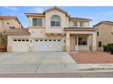 Charming two-story home featuring a three-car garage, landscaped front yard, and a classic desert color palette at 9630 Tuscola Ct, Las Vegas, NV 89148