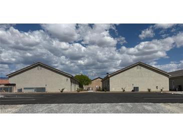 Exterior shot of the property featuring a well-maintained facade and parking at 1111 Sixshooter Ave, Pahrump, NV 89048