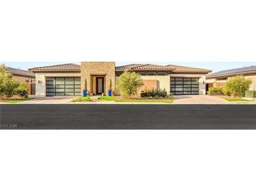 Modern home featuring a stone accent wall, black framed garage doors, and manicured landscaping at 11152 San Terrazo Pl, Las Vegas, NV 89141