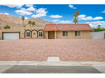 Charming single-story home with a red tile roof, desert landscaping, and mountain views at 138 Palma Del Rio, Las Vegas, NV 89110
